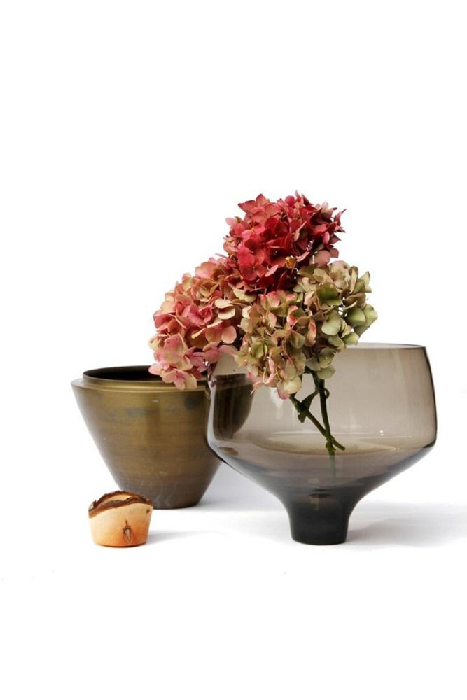 Two decorative vases with flowers on a white background