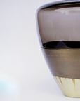 Close-up of a vase with gradient colors on a white background