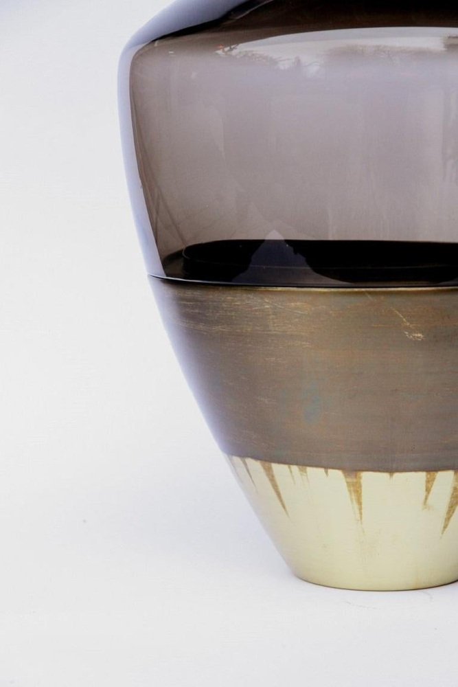 Close-up of a vase with gradient colors on a white background