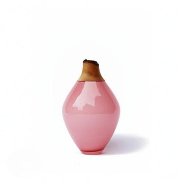 Pink ceramic vase with a wooden cap on a white background from Utopia & Utility available at Spacio retail stores in Mumbai & Kolkata. 
