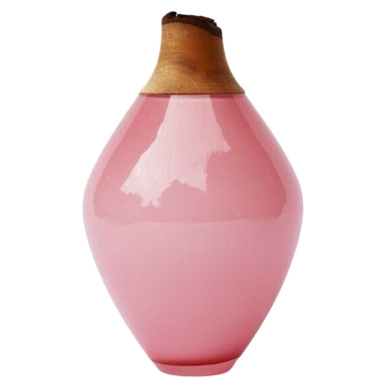 Pink vase with a wooden top on a white background