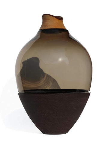 Vase with two-tone design made of wood, glass & ceramic on a white background from Utopia & Utility, available at Spacio retail stores in Mumbai & Kolkata. 