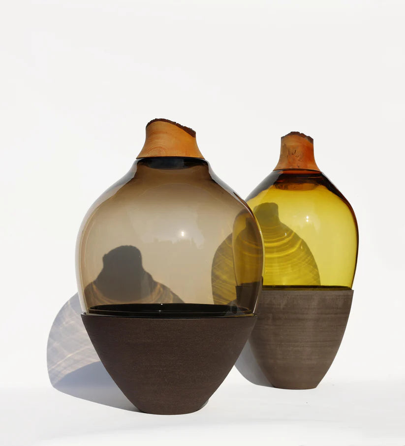Two glass vases with gradient colors on a white background