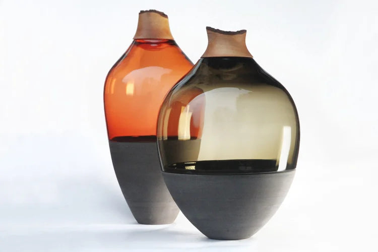 Two glass vases with gradient colors on a white background