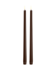 Two tall, dark brown led taper candles standing upright side by side on a plain white background.