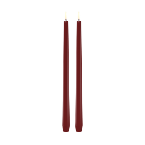Two tall, thin led taper candles in a deep burgundy red color, standing upright side-by-side against a solid white background.