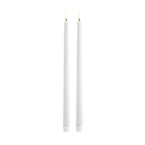 Two slim white led taper candles standing upright side by side on a plain white background.