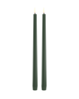 Two dark green slim LED taper candles standing upright side by side on a plain white background.