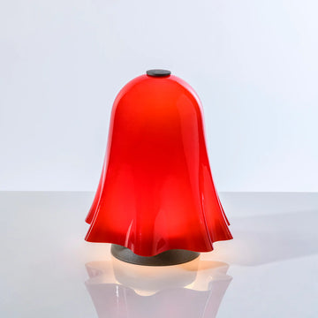 Red bell-shaped lamp on a white background from Venini at Spacio store in Mumbai