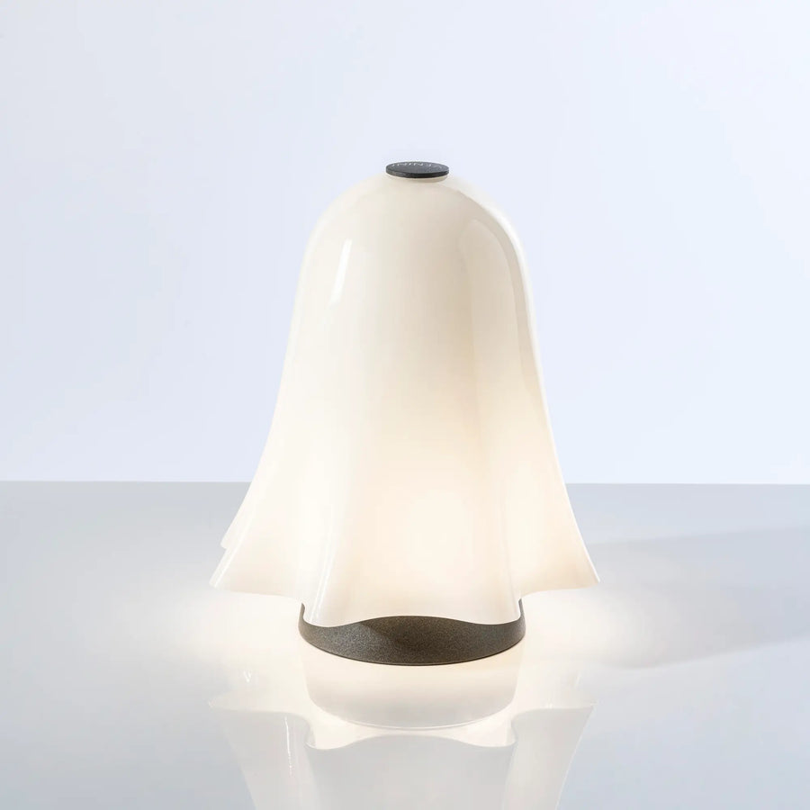 White lamp with black accents on a light gray background from Venini at Spacio store in Mumbai