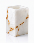 White quartz brush holder with gold accents on a white background