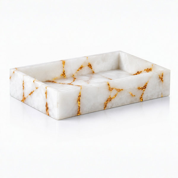 Rectangular white quartz towel tray with gold veining on a white background