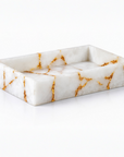 Rectangular white quartz towel tray with gold veining on a white background