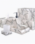 White quartz with silver foil bathroom accessory set including a tissue box, dispenser, and other items on a white background.