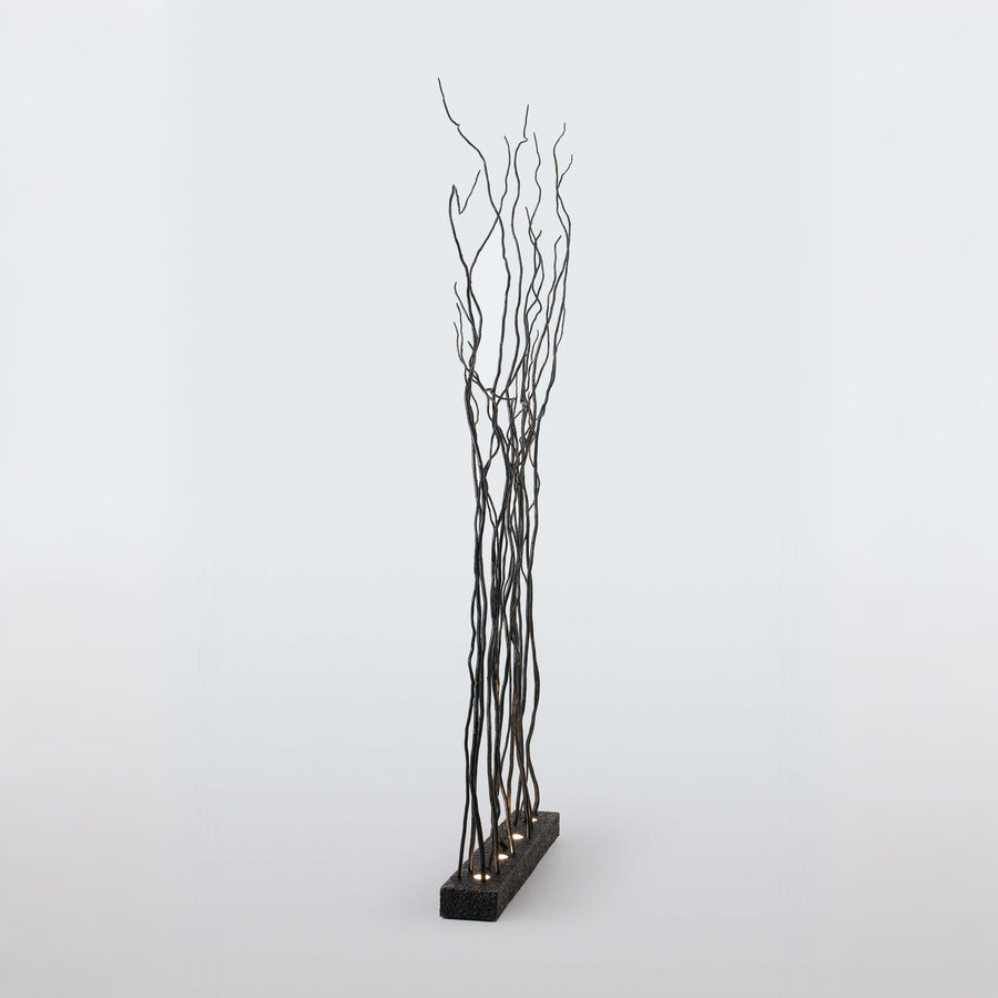 Decorative floor lamp with black branches on a white background