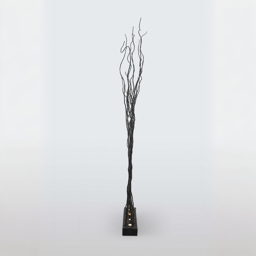 Decorative floor lamp with black branches on a white background