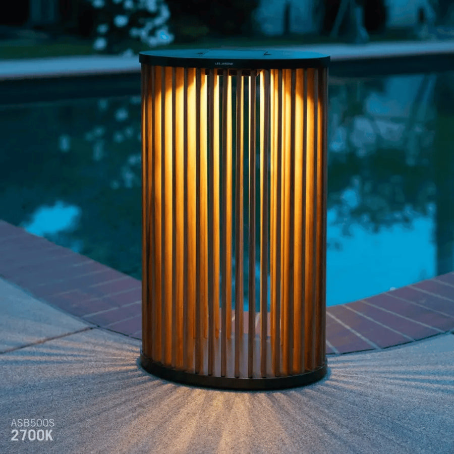 Decorative outdoor solar lamp with ribbed design by a poolside by Les Jardins available at Spacio retail stores in Mumbai & Kolkata. 