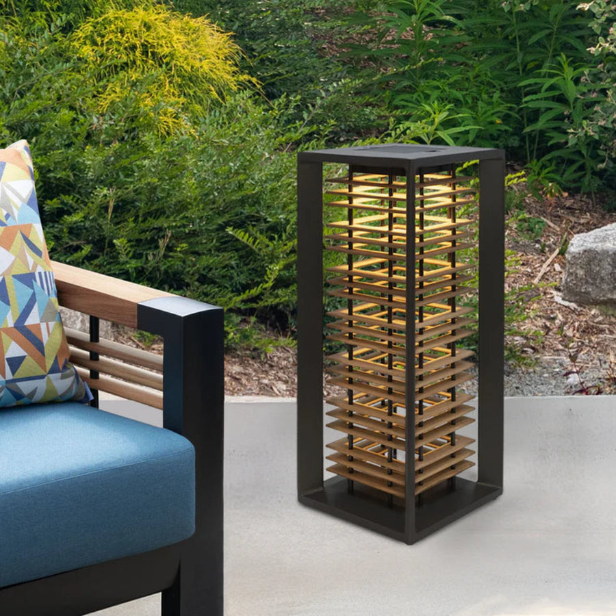 Outdoor setting with a wine rack and cushioned chair against a natural background by Les Jardins available at Spacio retail stores in Mumbai & Kolkata.  