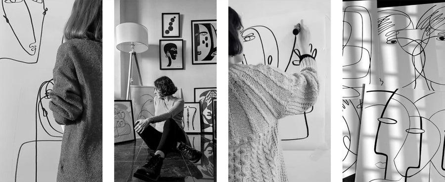 A black and white photo of a woman, Affreschi Inner Line Collection, drawing on a wall.