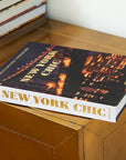 Assouline New York Chic coffee table book on a console table with other chic books available at Spacio India for luxury home decor accessories collection of Travel Coffee Table Books.