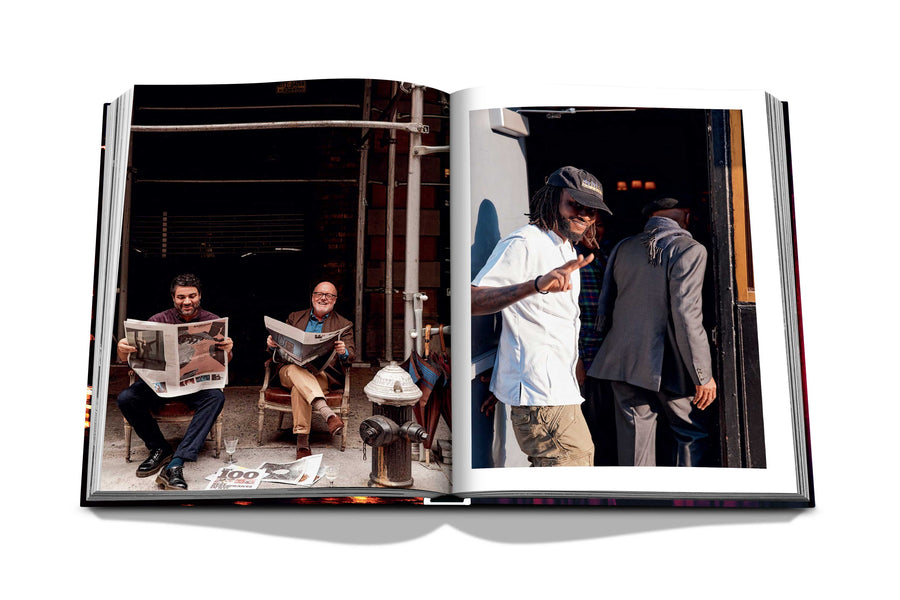 Assouline New York Chic coffee table book displaying photos of Men reading newspaper & a Rapper on white back ground available at Spacio India for luxury home decor accessories collection of Travel Coffee Table Books.