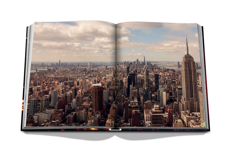 Assouline New York Chic coffee table book displaying drone shot photo whole New York city on white back ground available at Spacio India for luxury home decor accessories collection of Travel Coffee Table Books.