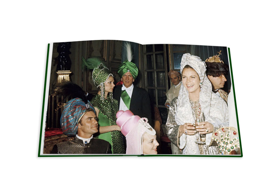 Assouline Bals: legendary costume balls of the twentieth century coffee table book displaying The Ball Of Baron Alexis De Rede In Paris,1969 on a white back ground available at Spacio India for luxury home decor accessories collection of Fashion Coffee Table Books.
