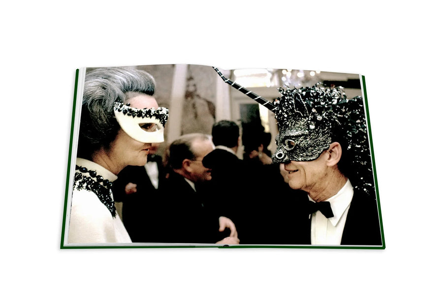 Assouline Bals: legendary costume balls of the twentieth century coffee table book displaying photos Truman Capote's "Black and White Ball" at the Plaza Hotel on a white back ground available at Spacio India for luxury home decor accessories collection of Fashion Coffee Table Books.
