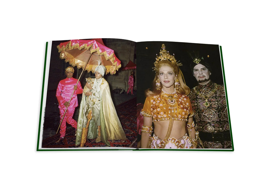 Assouline Bals: legendary costume balls of the twentieth century coffee table book displaying photos from The Ball Of Baron Alexis De Rede In Paris on a white back ground available at Spacio India for luxury home decor accessories collection of Fashion Coffee Table Books.
