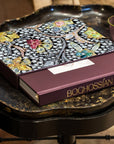 Assouline Boghossian: Expertise Craftsmanship Innovation coffee table book on black coffee table withpurple bowl at Spacio India for luxury home decor collection of Jewellery Coffee Table Books.