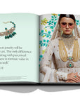 Assouline Diamonds: Diamonds Stories coffee table book displaying image of Model wearing Sabyasachi Gold-Green Jewellery in traditional outfit with his quote on a white back ground available at Spacio India for luxury home decor collection of Jewellery Coffee Table Books.