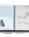 Assouline Diamonds: Diamonds Stories coffee table book displaying imag of sketches of diamonds & a hand with ring on it with information on a white back ground available at Spacio India for luxury home decor collection of Jewellery Coffee Table Books.