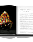 Assouline Dior by John Galliano coffee table book displaying photo of Princess Pocahontas a bustier dress in lilac taffeta, cream chamois blanket coat in yellow, green, blue and red velvet on a white back ground available at Spacio India for luxury home decor collection of Fashion Coffee Table Books.