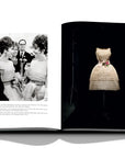 Assouline Dior by Marc Bohan coffee table book displaying photo of Spring/Summer 1961. Worn by Elizabeth Taylor and Gina Lollobrigida on a white back ground available at Spacio India for luxury home decor collection of Fashion Coffee Table Books.