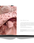 Assouline Dior by Marc Bohan coffee table book displaying photo of light pink gown's detailed work on a white back ground available at Spacio India for luxury home decor collection of Fashion Coffee Table Books.