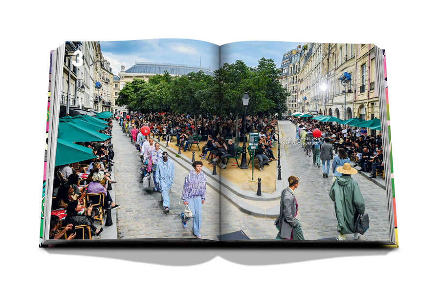 Assouline Louis Vuitton: Virgil Abloh Classic Cartoon Cover coffee table book displaying photo of Louis Vuitton’s menswear spring/summer 2020 fashion show on a white back ground available at Spacio India for luxury home decor accessories collection of Fashion Coffee Table Books.