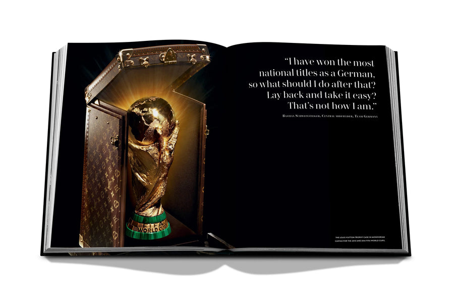 Assouline Louis Vuitton: Trophy Trunks coffee table book displaying photo of Louis Vuitton World Cup Trophy 2010 on a white back ground available at Spacio India for luxury home decor accessories collection of Fashion Coffee Table Books.