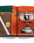 Assouline Louis Vuitton: Trophy Trunks coffee table book displaying image of picture shows the trophy of the tennis open of rome on may 17 on a white back ground available at Spacio India for luxury home decor accessories collection of Fashion Coffee Table Books.