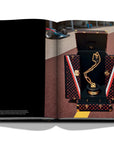 Assouline Louis Vuitton: Trophy Trunks coffee table book displaying image of F1 Monaco Trophy Louis Vuitton on a white back ground available at Spacio India for luxury home decor accessories collection of Fashion Coffee Table Books.