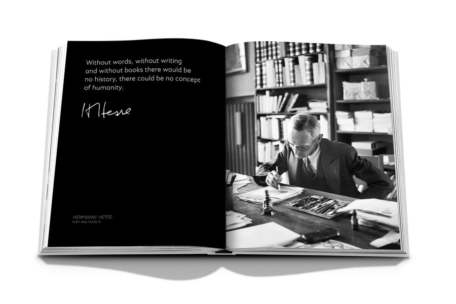 Assouline Montblanc coffee table book displaying picture of The English author, poet and Nobel laureate in literature of the year 1946, Hermann Hesse works on an illustration in the study of his residence in Montagnola & his Signature available at Spacio India for luxury home decor accessories collection of Fashion Coffee Table Books.
