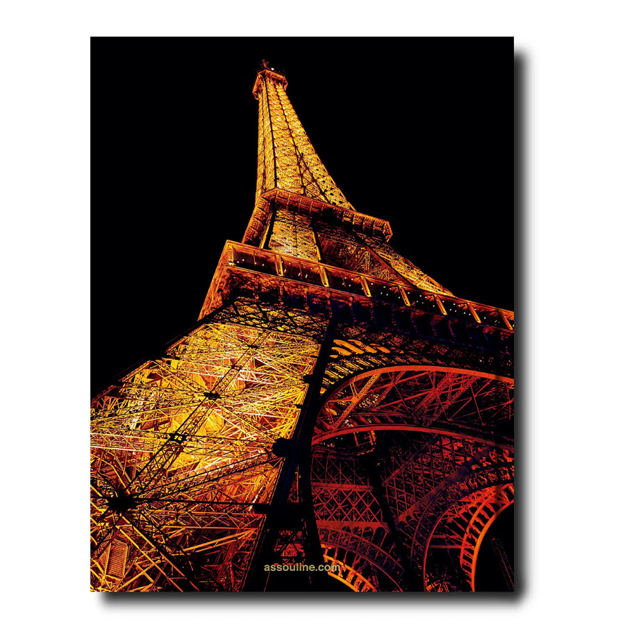 The back page of Assouline Paris Chic coffee table book displaying photo of low angle of Eiffel Tower on white back ground available at Spacio India for luxury home decor accessories collection of Travel Coffee Table Books.