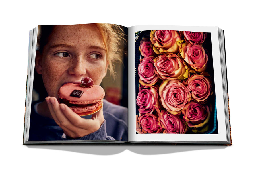 Assouline Paris Chic coffee table book displaying photos of Roses & a girl eating donut in Paris on white back ground available at Spacio India for luxury home decor accessories collection of Travel Coffee Table Books.