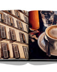 Assouline Paris Chic coffee table book displaying photos of Paris Apartments Windows & Cup of Coffee on white back ground available at Spacio India for luxury home decor accessories collection of Travel Coffee Table Books.