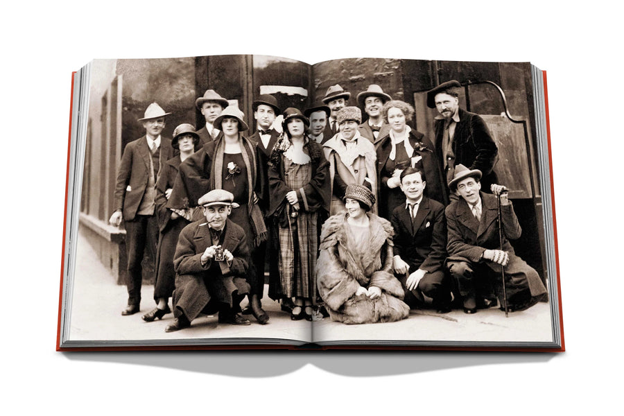 Assouline Paris in the 1920s with Kiki De Montparnasse Coffee Table Book displaying photo of American Visual Artist Man Ray with other Artists at the Jockey in Paris, on a white back ground available at Spacio India for luxury home decor accessories collection of Travel Coffee Table Books.