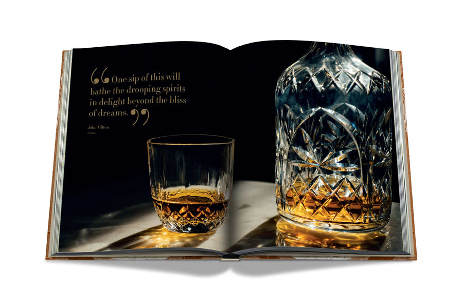 Assouline Coffee Table Book The Impossible Collection of Whiskey page displaying a photo of the glass & decanter on a white back ground available at Spacio India for luxury home decor accessories collection of Ultimate Coffee Table Books.