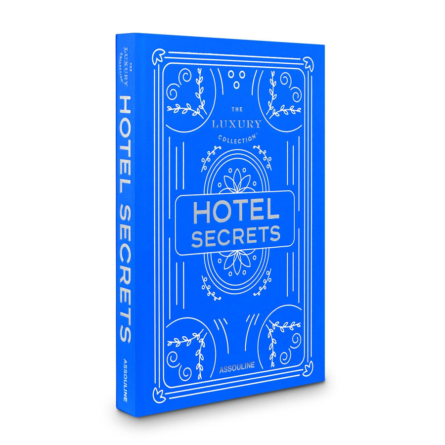 Side look of Assouline The Luxury Collection: Hotel Secrets coffee table book on a white back ground available at Spacio India for luxury home decor accessories collection of Travel Coffee Table Books.