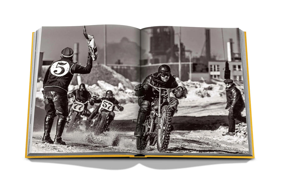 Assouline The Race of Gentlemen coffee table book displaying a man in a motorcycle race on a white back ground available at Spacio India for luxury home decor accessories collection of Sports Coffee Table Books.