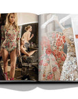 Assouline Zuhair Murad coffee table book cover with page of fashion model & fashion dresses on white back ground available at Spacio India for luxury home decor accessories collection of Fashion Coffee Table Books.