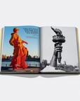 An open book laid flat on a light gray background, showing two printed pages. The left page has a color photograph of a person in an orange outfit standing outdoors near water and a city skyline, with text at the top.