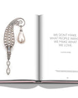 Assouline G Glenn: Spiro the art of a jewel coffee table book displaying photo of Glenn Spiro white pearl and diamond brooch with text quote on a white back ground available at Spacio India for luxury home decor collection of Jewellery Coffee Table Books.